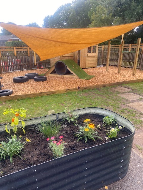 pre school garden after raised beds sail canopy